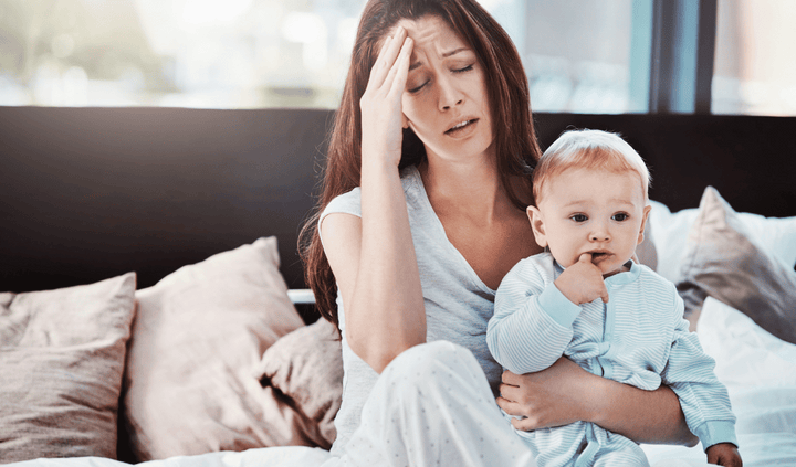 Stressed mom holding baby with Separation anxiety