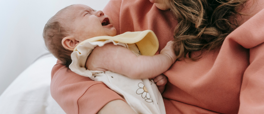 mom holding crying baby
